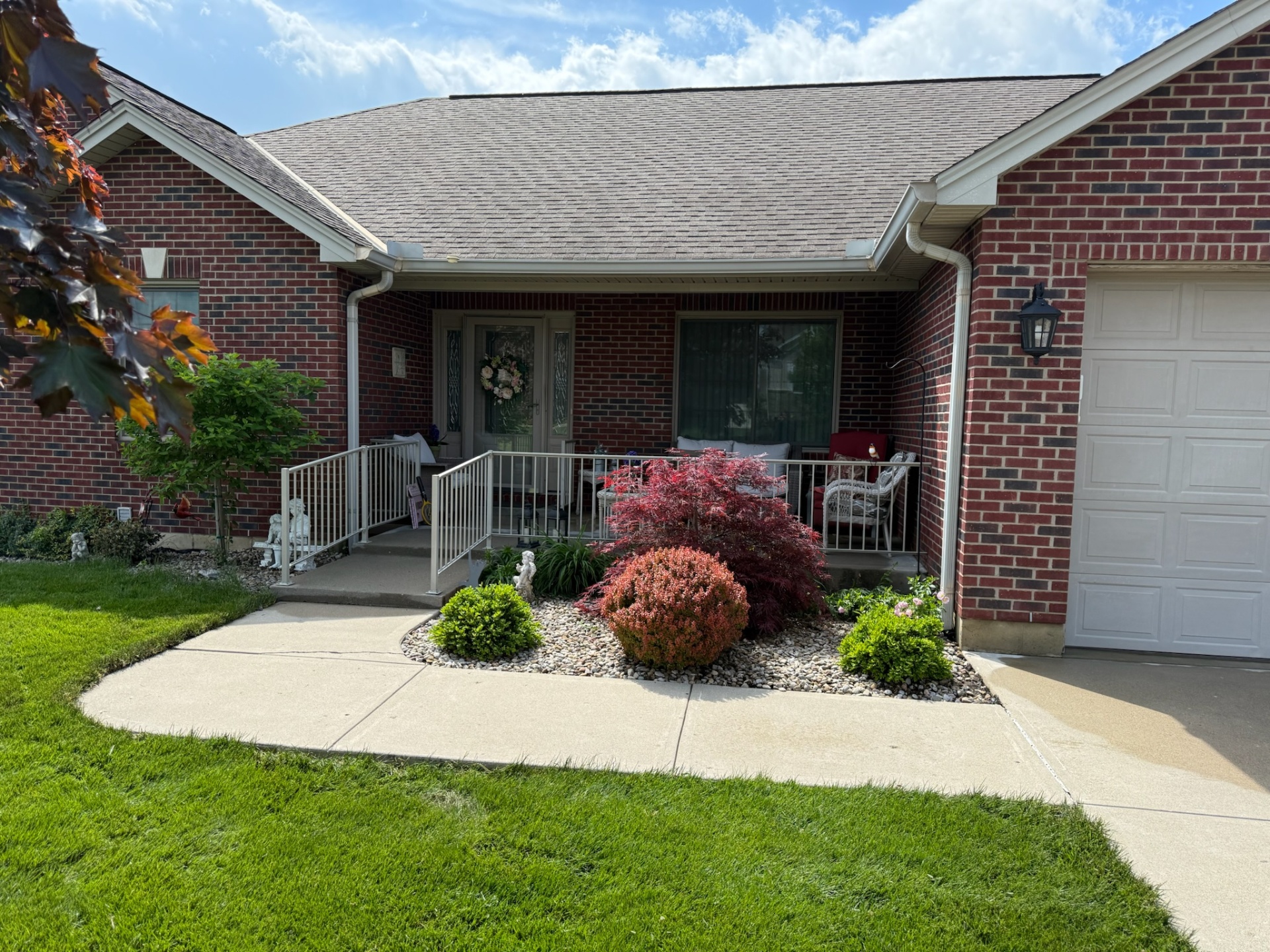 Brick ranch home with freshly cleaned concrete walkway